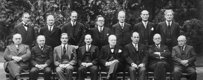 The Churchill Coalition Government 11 May 1940 - 23 May 1945: The Churchill Coalition War Cabinet: standing, from left to right, Sir Archibald Sinclair, Mr A V Alexander, Lord Cranborne, Herbert Morrison, Lord Moyne, Captain Margesson and Brendan Bracken. Seated, from left to right, Ernest Bevin, Lord Beaverbrook, Anthony Eden, Clement Attlee, Winston Churchill, Sir John Anderson, Arthur Greenwood and Sir Kingsley Wood.