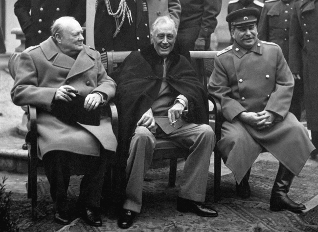 Conference of the Big Three at Yalta makes final plans for the defeat of Germany. Here the "Big Three" sit on the patio together, Prime Minister Winston S. Churchill, President Franklin D. Roosevelt, and Premier Josef Stalin. February 1945. 